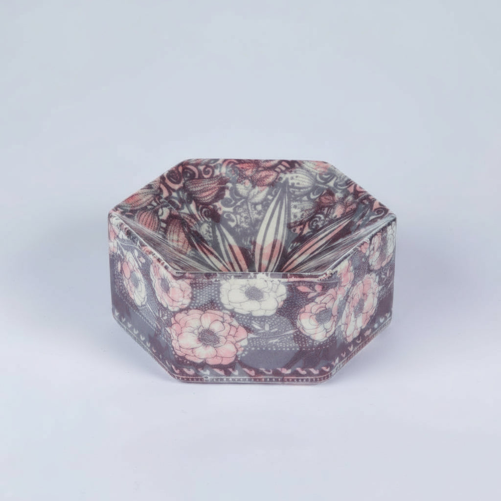 Hexagonal decorative box with floral pattern on a light gray background
